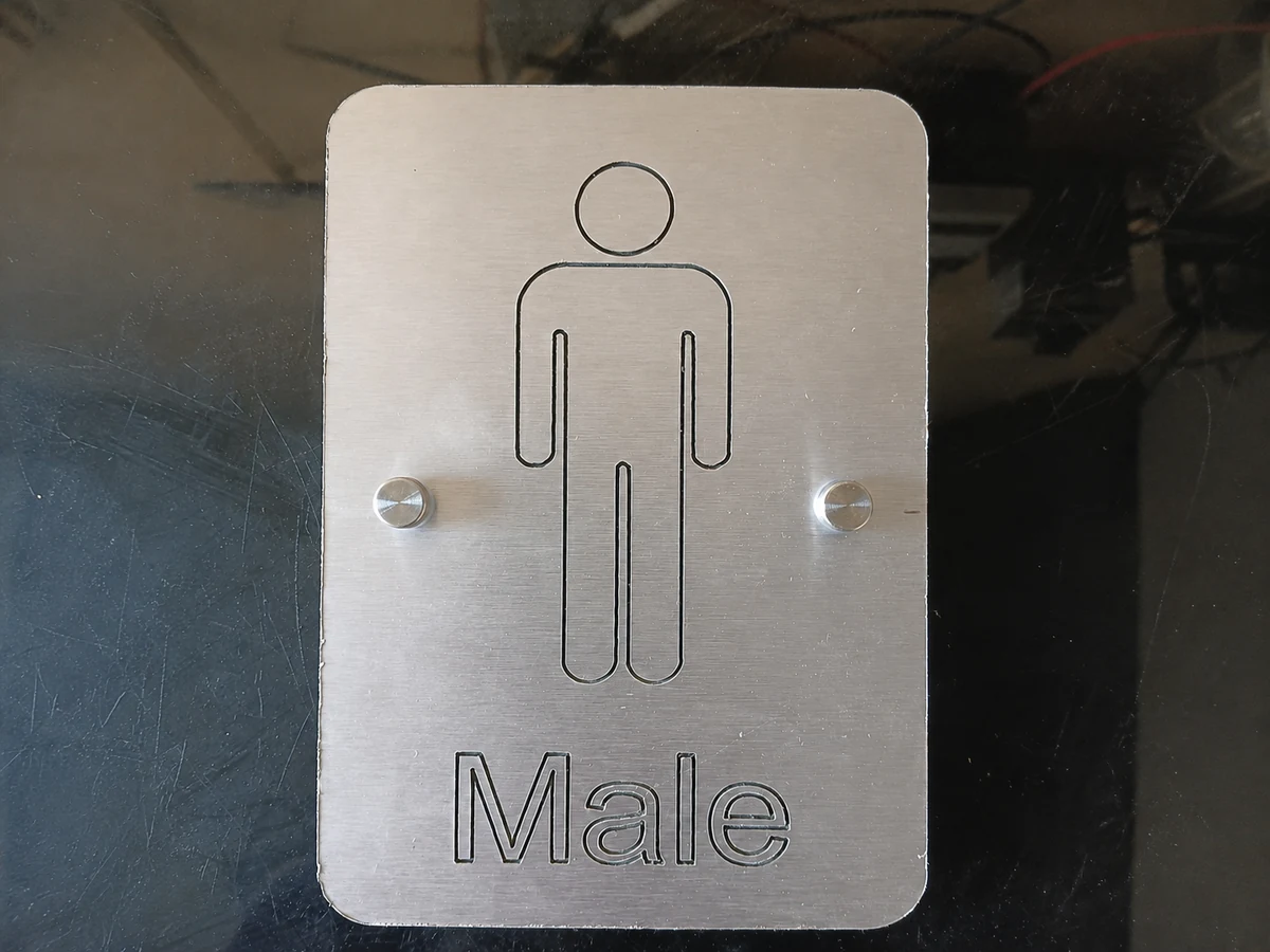 Brushed aluminium male sign made by H&S Signs