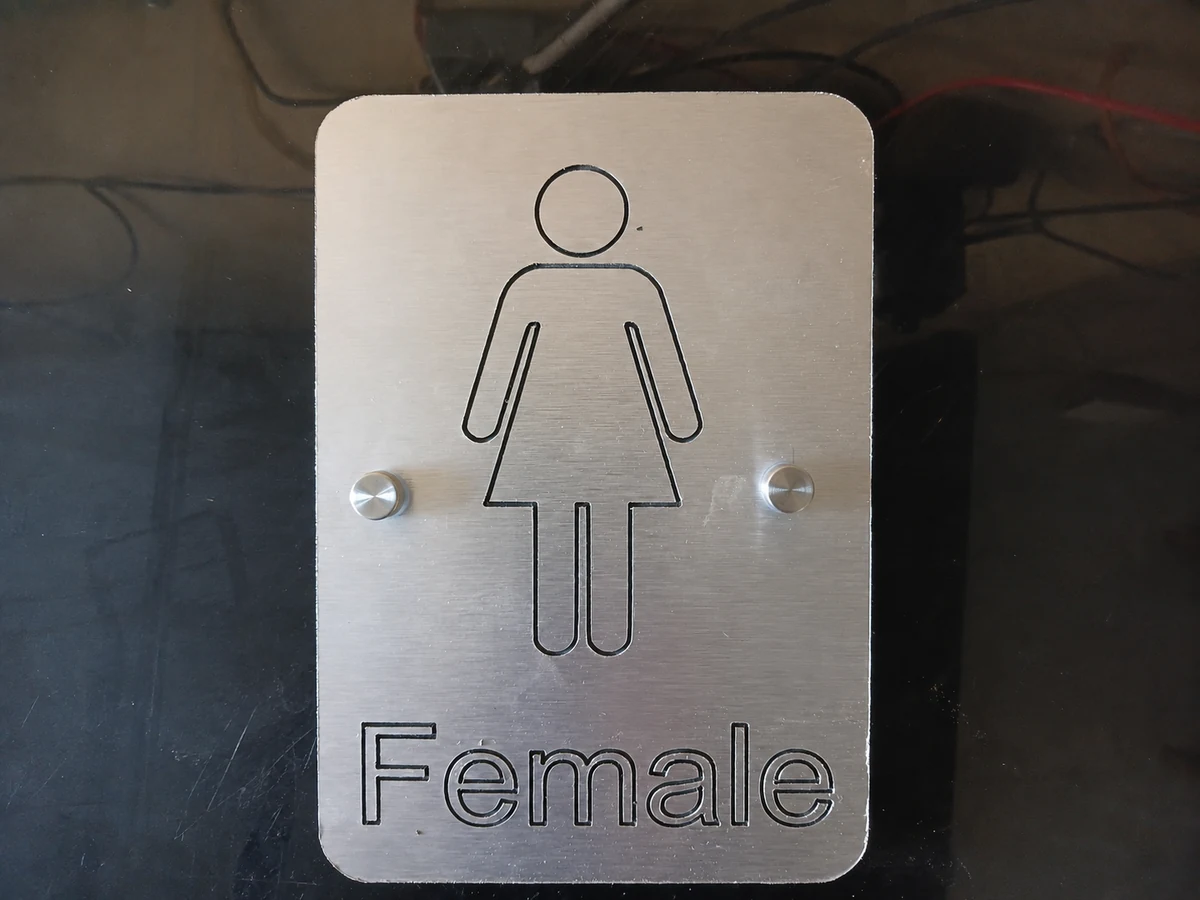 Brushed aluminium female sign made by H&S Signs